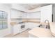 This kitchen features a corner sink, matching appliances, and lots of bright light at 6158 Cavan St, Englewood, FL 34224