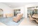 Open concept living space with tile floors, comfy furniture, and lots of natural light at 6158 Cavan St, Englewood, FL 34224
