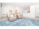 Bright and airy living room with plush blue carpet, two recliners, and an open floor plan at 6158 Cavan St, Englewood, FL 34224