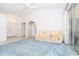 Bright and airy living room with plush blue carpet, a comfortable sofa, and slider access to the lanai at 6158 Cavan St, Englewood, FL 34224