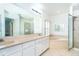 Main bathroom featuring large soaking tub, glass-enclosed shower, and double sinks at 6158 Cavan St, Englewood, FL 34224