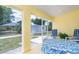 Enclosed patio features seating, views of yard, and durable flooring at 6158 Cavan St, Englewood, FL 34224
