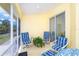 Relaxing screened patio with seating, ceiling fan, and plants at 6158 Cavan St, Englewood, FL 34224