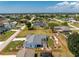 Beautiful home with a screened lanai, complemented by lush landscaping and a fenced yard at 7048 Inland St, Englewood, FL 34224