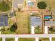The aerial view shows the property, large lot, surrounding landscaping, and neighborhood layout at 7048 Inland St, Englewood, FL 34224