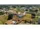 Aerial view showcases the property's expansive yard and outdoor living spaces with hot tub and pool nearby at 7048 Inland St, Englewood, FL 34224