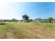 Spacious grassy backyard with lush green surroundings, perfect for outdoor activities and relaxation at 7048 Inland St, Englewood, FL 34224