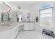 Spacious bathroom featuring dual vanities, well-lit mirrors, and elegant fixtures for a luxurious feel at 7048 Inland St, Englewood, FL 34224