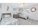Bright bedroom featuring two beds, gray walls, stylish décor, carpeted floors and sunlit windows at 7048 Inland St, Englewood, FL 34224