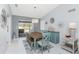 Bright dining room showcases a rustic wood table, stylish decor, and seamless access to the patio at 7048 Inland St, Englewood, FL 34224