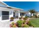 Welcoming home entrance with lush landscaping, potted plants, and a decorative front door at 7048 Inland St, Englewood, FL 34224
