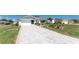 Beautiful home featuring a long driveway, fresh landscaping, and a well-maintained lawn at 7048 Inland St, Englewood, FL 34224
