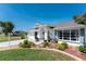 Charming home showcasing meticulous landscaping with vibrant plants, stone accents, and inviting curb appeal at 7048 Inland St, Englewood, FL 34224