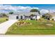 Charming single-story home boasts a well-manicured lawn with beautiful landscaping and a circular driveway at 7048 Inland St, Englewood, FL 34224