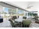 Covered lanai with comfortable seating, ceiling fans, and tranquil views of the landscaped yard at 7048 Inland St, Englewood, FL 34224