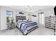 Serene bedroom featuring modern decor, comfortable bedding, and ample natural light from the windows at 7048 Inland St, Englewood, FL 34224