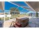 A screened-in patio showcasing a hot tub, offering a private retreat for relaxation and outdoor enjoyment at 7048 Inland St, Englewood, FL 34224