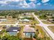 Aerial view of a single-Gathering home that showcases a screened pool enclosure, lush landscaping, and a well-maintained yard at 7247 Brookhaven Ter, Englewood, FL 34224