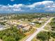 Aerial view of a single-Gathering home with screened pool and landscaping in a residential neighborhood at 7247 Brookhaven Ter, Englewood, FL 34224