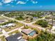 Aerial view of single-Gathering home with screened pool enclosure surrounded by mature trees and landscaping at 7247 Brookhaven Ter, Englewood, FL 34224