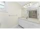 Bathroom with walk-in shower, large mirror, natural light and ample counter space at 7247 Brookhaven Ter, Englewood, FL 34224