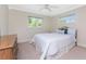 Bedroom showcasing large window, carpet, ceiling fan, and natural light at 7247 Brookhaven Ter, Englewood, FL 34224