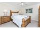 Bright bedroom features wood furniture, ceiling fan, carpet and serene natural light at 7247 Brookhaven Ter, Englewood, FL 34224