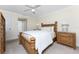 Cozy bedroom with a wood frame bed, carpet, ceiling fan and ample lighting at 7247 Brookhaven Ter, Englewood, FL 34224