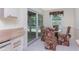Bright breakfast nook features tile flooring, garden view and sliding glass doors to the lanai at 7247 Brookhaven Ter, Englewood, FL 34224