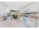 Bright kitchen with white appliances and a view of the dining room at 7247 Brookhaven Ter, Englewood, FL 34224