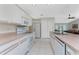 Well-lit kitchen featuring white cabinets and a full-size stainless steel appliance package at 7247 Brookhaven Ter, Englewood, FL 34224