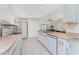Open kitchen showcasing ample countertop space, modern appliances, and seamless flow to the living area at 7247 Brookhaven Ter, Englewood, FL 34224