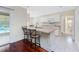 Bright open kitchen with bar seating and a view of the pool at 7247 Brookhaven Ter, Englewood, FL 34224