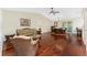 Bright, spacious living room with hardwood floors and comfortable wicker furniture at 7247 Brookhaven Ter, Englewood, FL 34224