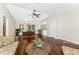 Open living space with hardwood floors flowing into dining and kitchen areas at 7247 Brookhaven Ter, Englewood, FL 34224