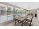 Enclosed patio featuring tile flooring, ceiling fan, and backyard pool view at 7247 Brookhaven Ter, Englewood, FL 34224