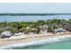 Aerial view of beachfront properties, showcasing water views and lush tropical landscaping at 7420 Manasota Key Rd, Englewood, FL 34223