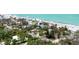 Aerial view of stunning beachside homes along the water, nestled among trees and greenery at 7420 Manasota Key Rd, Englewood, FL 34223