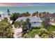 Aerial view of a beachfront property surrounded by lush greenery and the ocean at 7420 Manasota Key Rd, Englewood, FL 34223