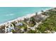 Aerial view of beachfront homes on sandy beach with the turquoise water and tropical greenery at 7420 Manasota Key Rd, Englewood, FL 34223
