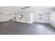 Open basement space with concrete floor, white walls and ceilings, and two windows at 7420 Manasota Key Rd, Englewood, FL 34223
