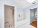 Bright white tiled bathroom with shower stall and separate soaking tub at 7420 Manasota Key Rd, Englewood, FL 34223