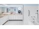Large white tiled bathroom featuring double sinks and walk in shower at 7420 Manasota Key Rd, Englewood, FL 34223