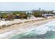 Beautiful beachfront homes with palm trees along the sandy shoreline and blue waters at 7420 Manasota Key Rd, Englewood, FL 34223