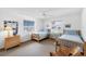 Neutral bedroom with two twin beds, blue bedding, and a ceiling fan at 7420 Manasota Key Rd, Englewood, FL 34223