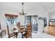 Bright dining room with seating for four, and sliding glass door to outdoor living at 7420 Manasota Key Rd, Englewood, FL 34223