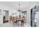Bright dining room with seating for six, and sliding glass door to outdoor living at 7420 Manasota Key Rd, Englewood, FL 34223