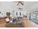 Light and bright living room with hardwood floors and wicker furniture, leading out to the deck at 7420 Manasota Key Rd, Englewood, FL 34223