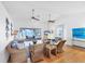 Bright living room with wicker furniture, ceiling fans, and scenic views through the screened lanai at 7420 Manasota Key Rd, Englewood, FL 34223