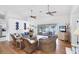 Bright living room with wicker furniture, ceiling fans, and a seamless transition to a screened lanai at 7420 Manasota Key Rd, Englewood, FL 34223